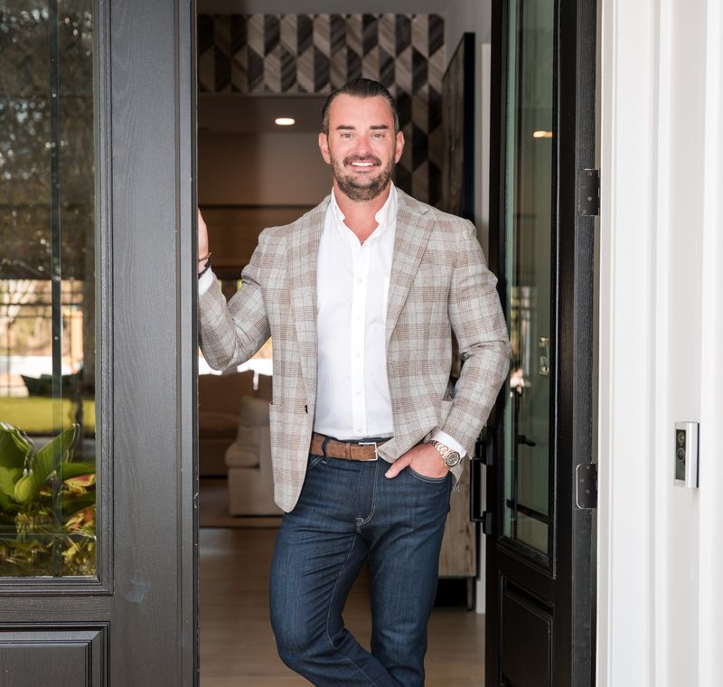 Nick Strumke, REALTOR® with CENTURY 21 Palms Realty, standing in the doorway of a home